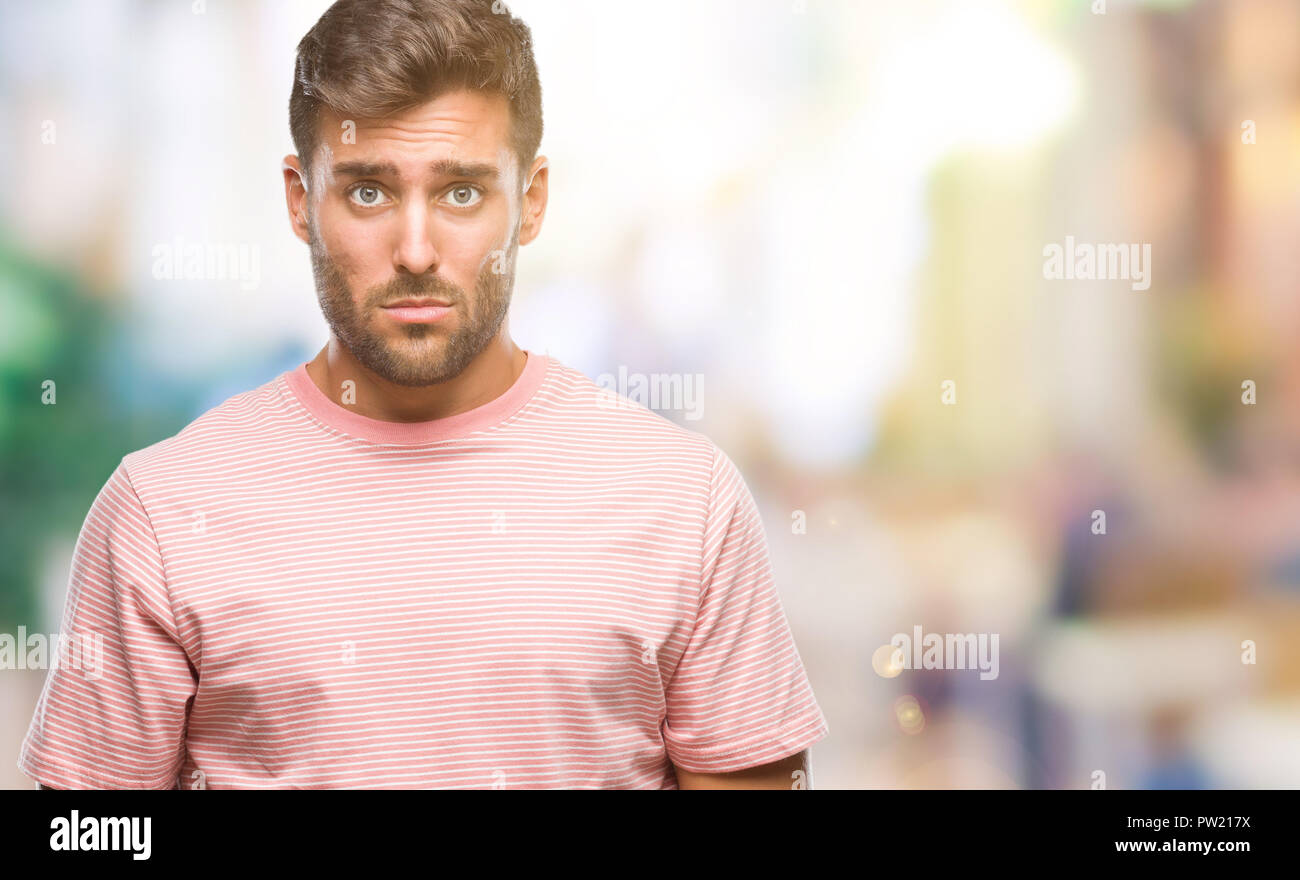 Young handsome man over isolated background depressed and worry for distress, crying angry and afraid. Sad expression. Stock Photo