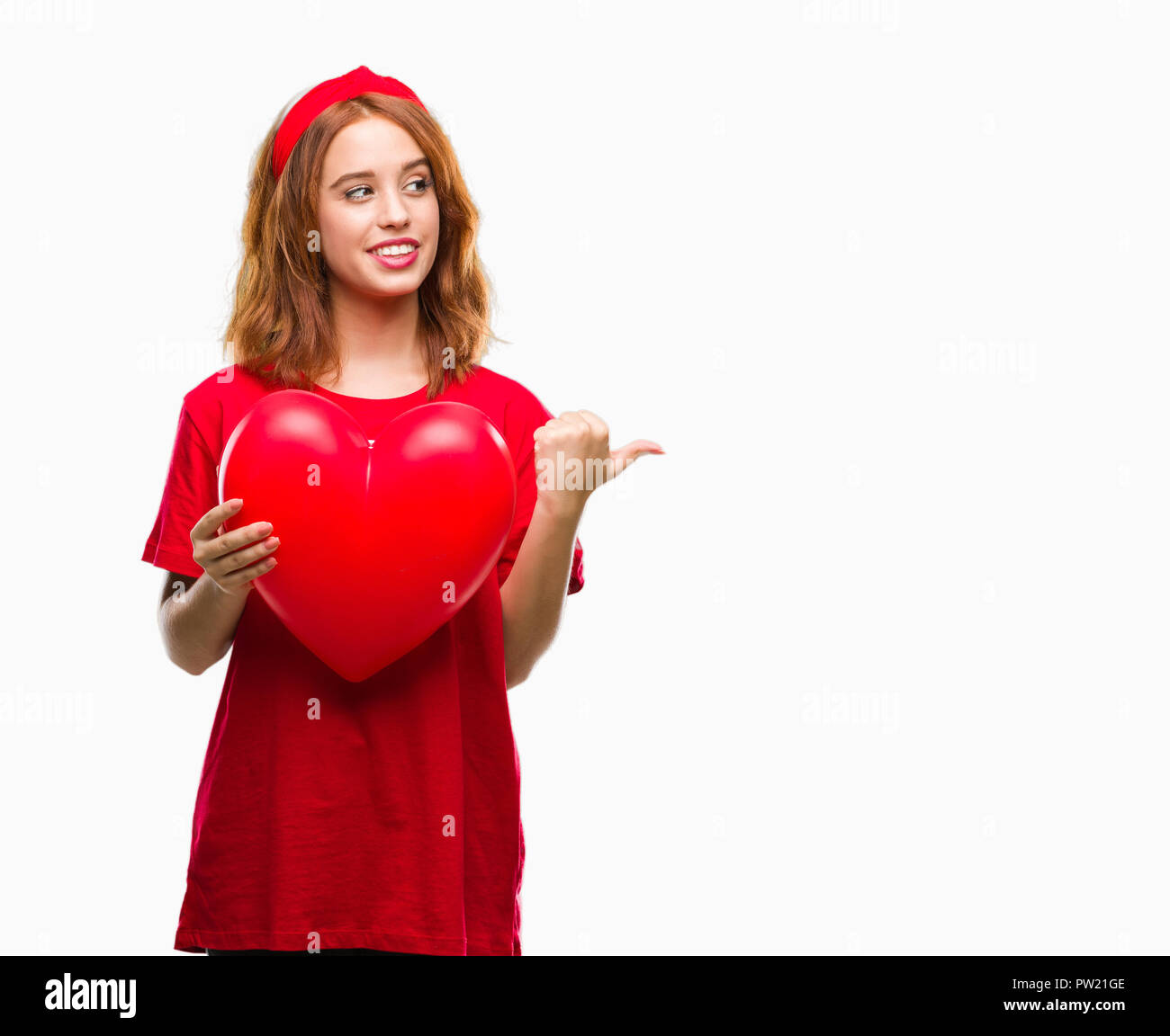 Young beautiful woman holding red heart in love over isolated ...