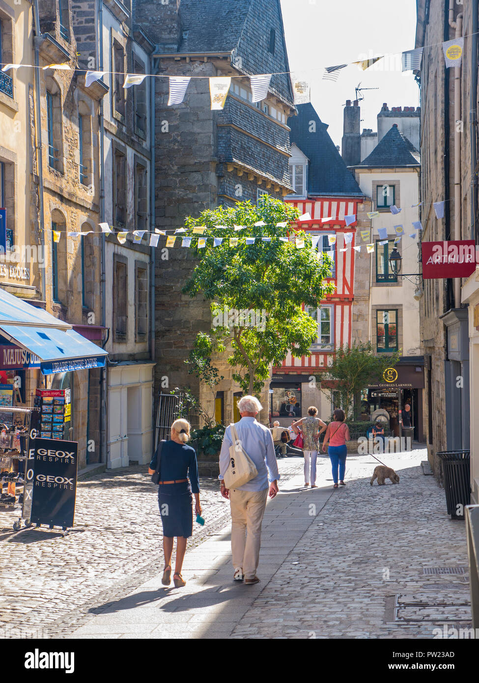 Quimper old town historic medieval pedestrian zone shopping centre with summer sun shoppers tourists & visitors Quimper Brittany Finistère France Stock Photo