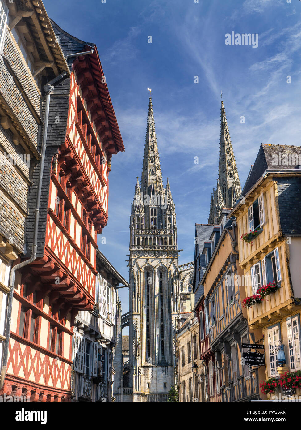 Quimper Brittany medieval half timbered old historic shopping quarter Cathedral spire in background Quimper Brittany Bretagne Finistere  France Stock Photo