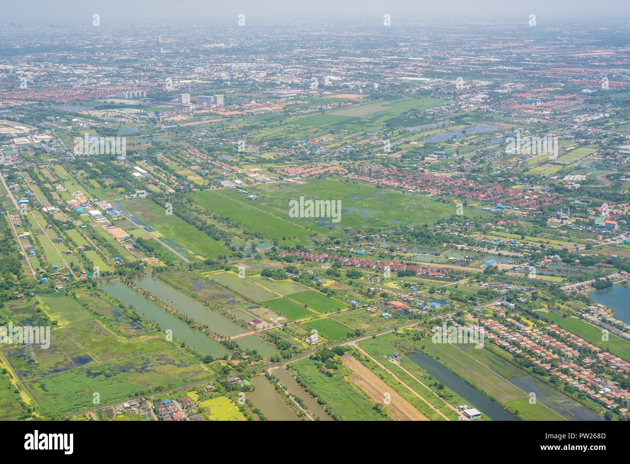 Encroachment of housing estate which affect the environment and agricultural property Stock Photo