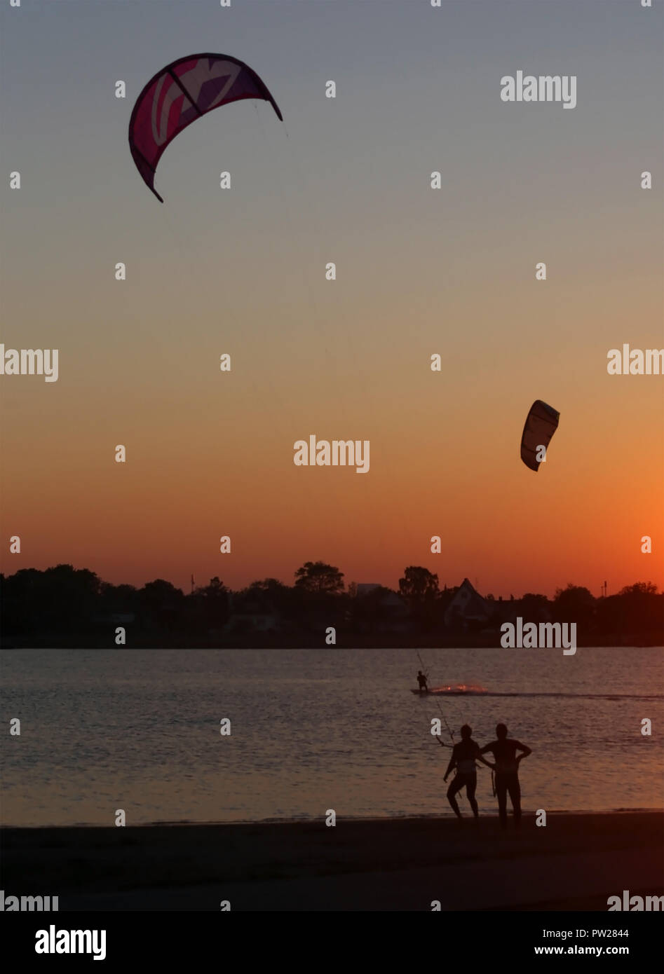 Learning kite surfing while the sun getting set Stock Photo Alamy