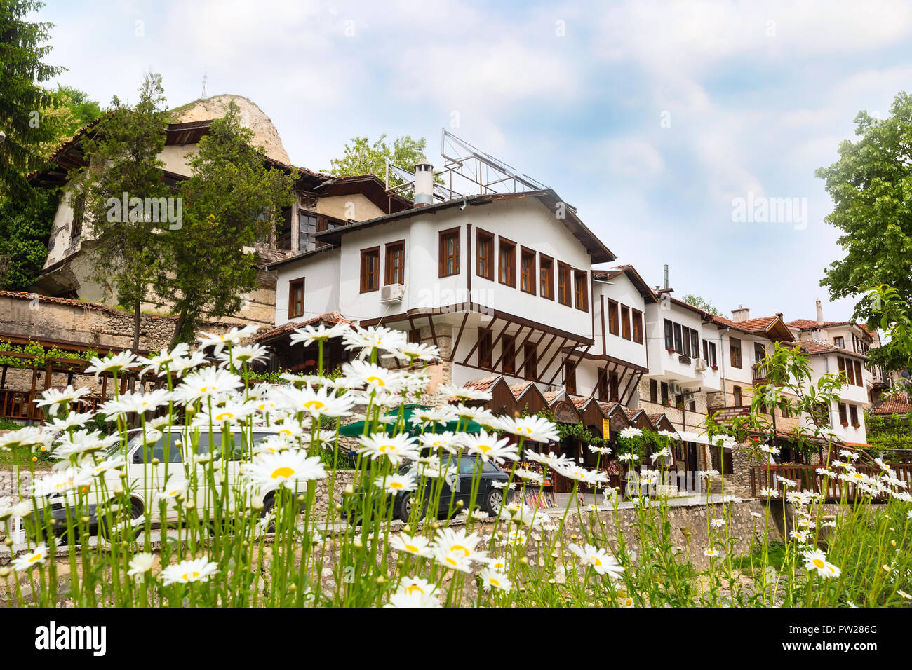 view with traditional bulgarian houses of Revival period and flowers in Melnik town, Bulgaria Stock Photo