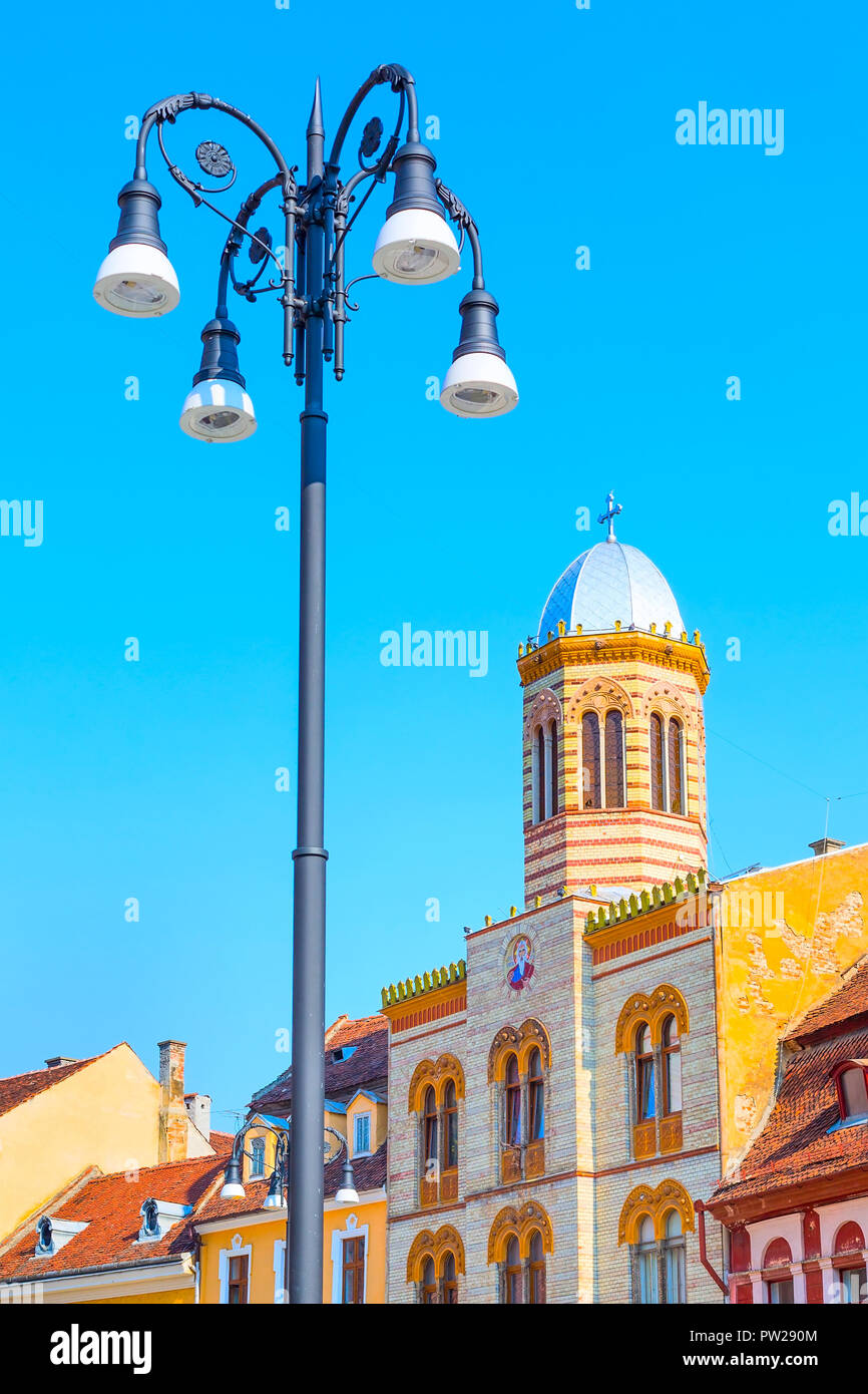 Orthodox Church at Piata Sfatului and street light in the center of Brasov, Romania Stock Photo