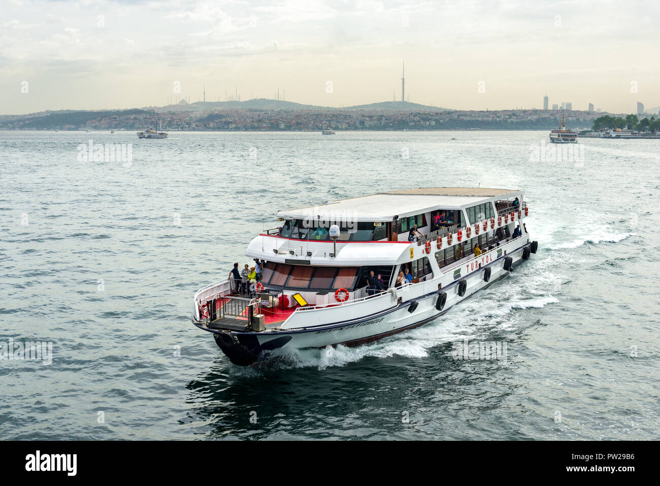A Turyol passenger ferry sails on the Bosphorus with passengers aboard, Istanbul, Turkey Stock Photo