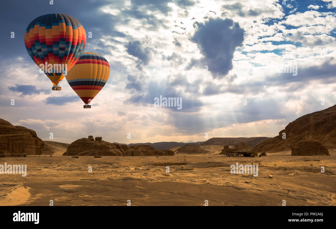 Hot Air Balloon travel over desert Stock Photo