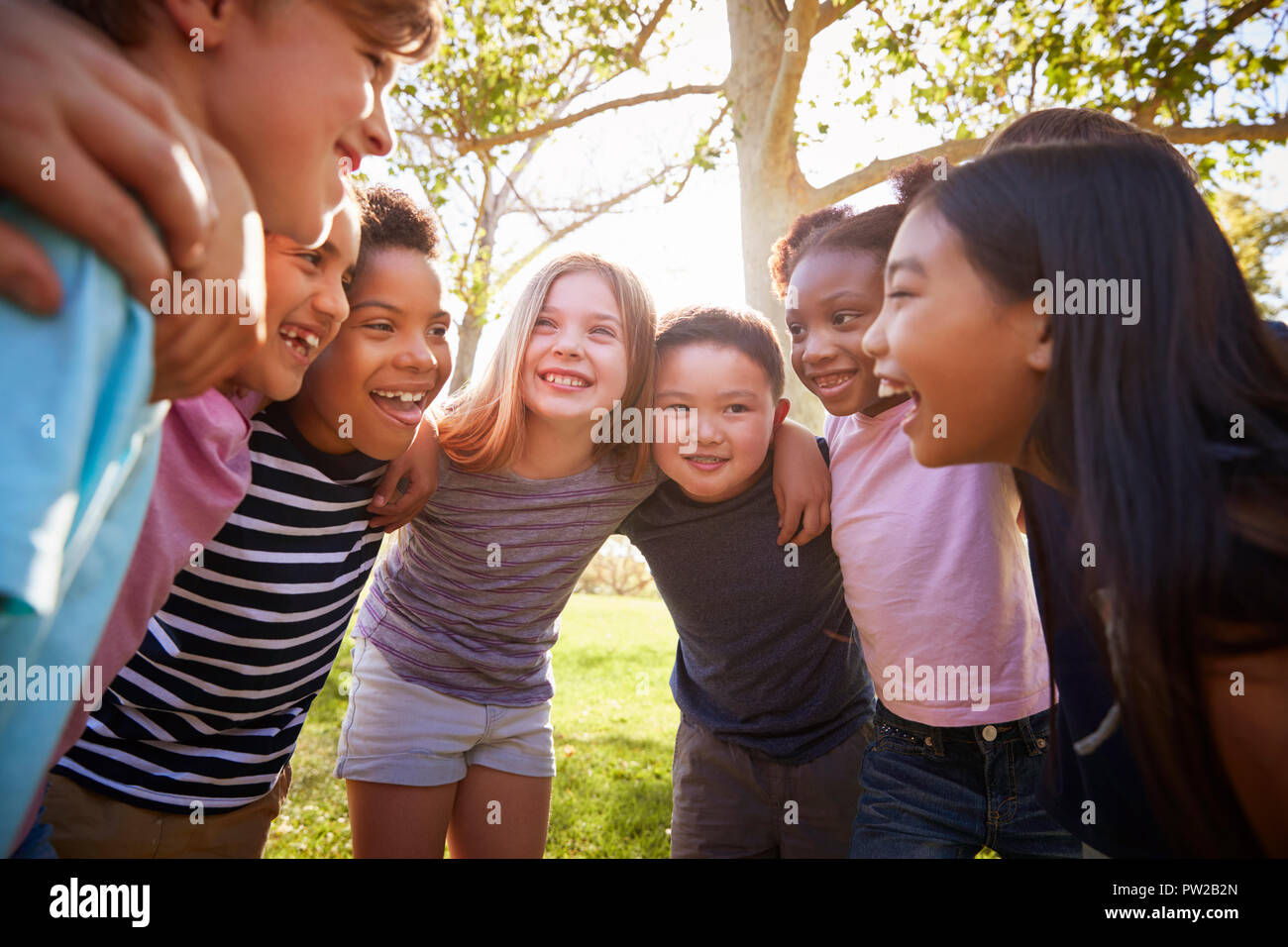 Group of schoolchildren embrace standing in a circle Stock Photo - Alamy