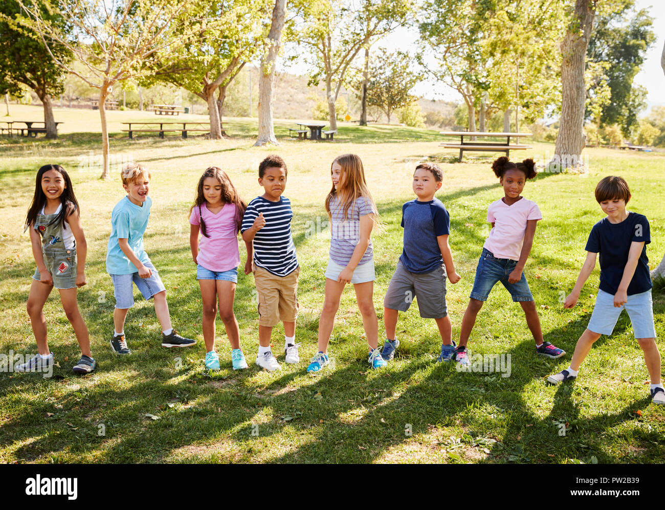 Multi-ethnic group of schoolchildren playing in park Stock Photo - Alamy