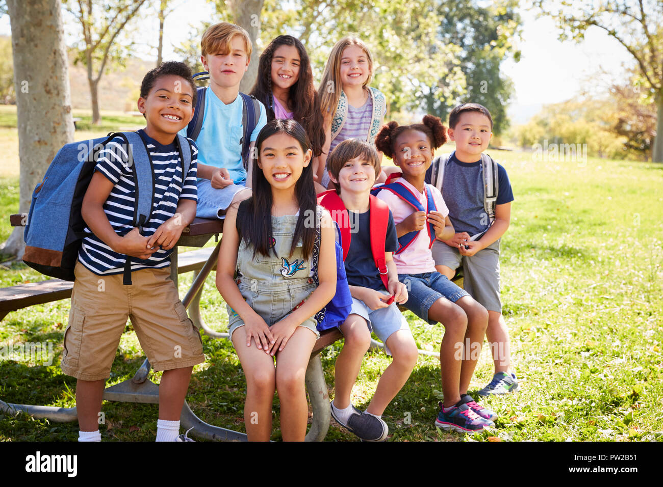 Multi-ethnic group of school kids hanging out on school trip Stock Photo