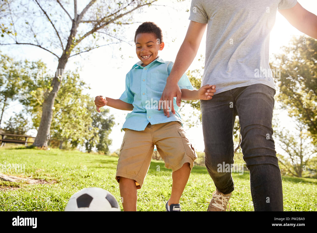 Father And Son Playing Soccer In Park Together Stock Photo - Alamy