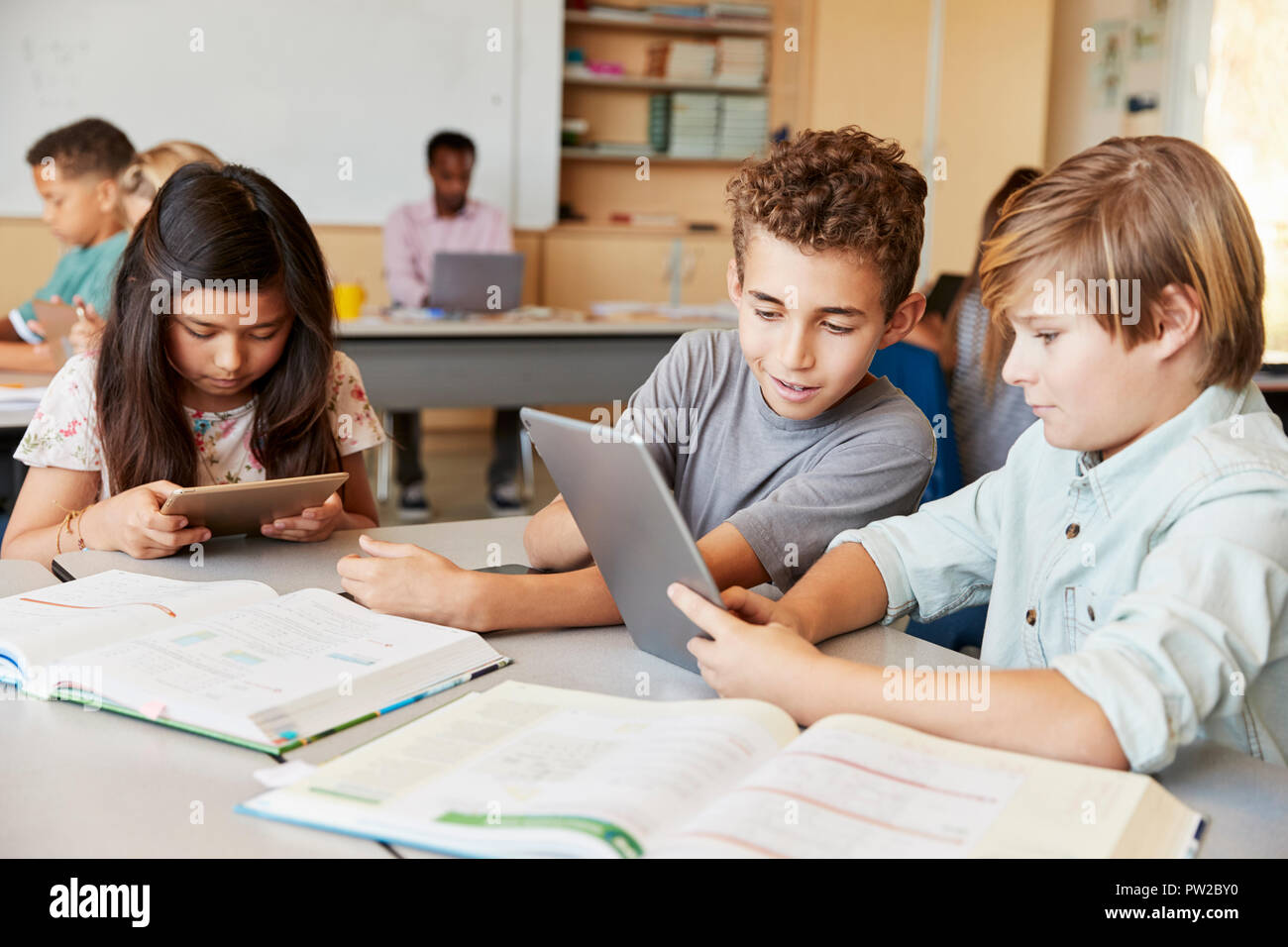 Schoolboys working together with tablet computer in class Stock Photo