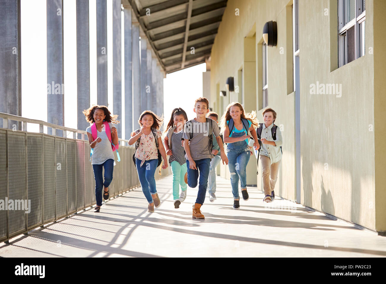 Group of elementary school kids running in a school corridor Stock ...