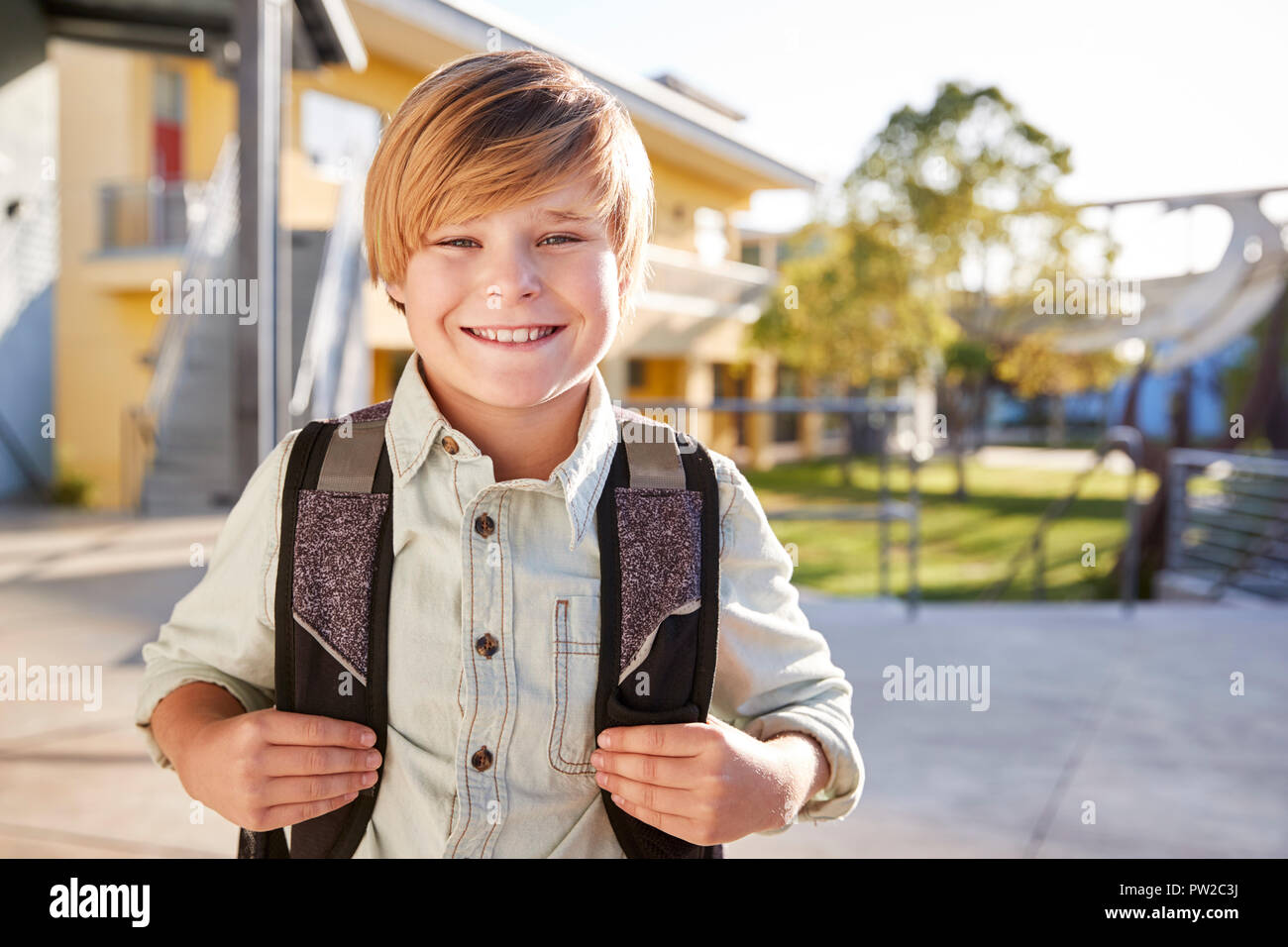Portrait of smiling elementary school boy with his backpack Stock Photo ...