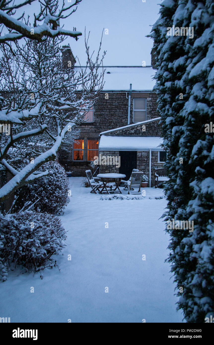 Domestic garden under snow. Haydon, Somerset, UK Stock Photo