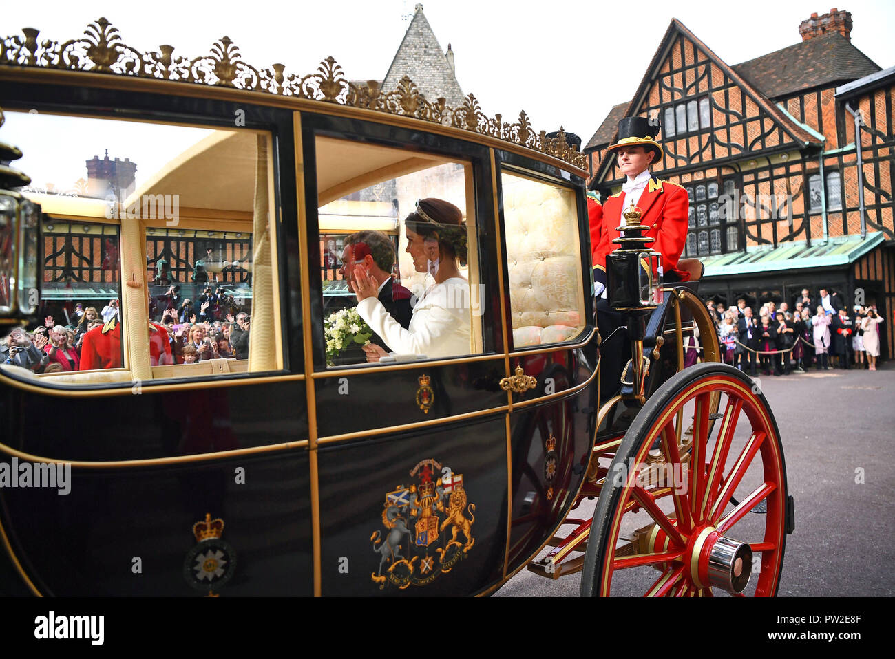 Princess Eugenie and her husband Jack Brooksbank travel in the Scottish State Coach at the start of their carriage procession following their wedding at St George's Chapel, Windsor Castle. Stock Photo