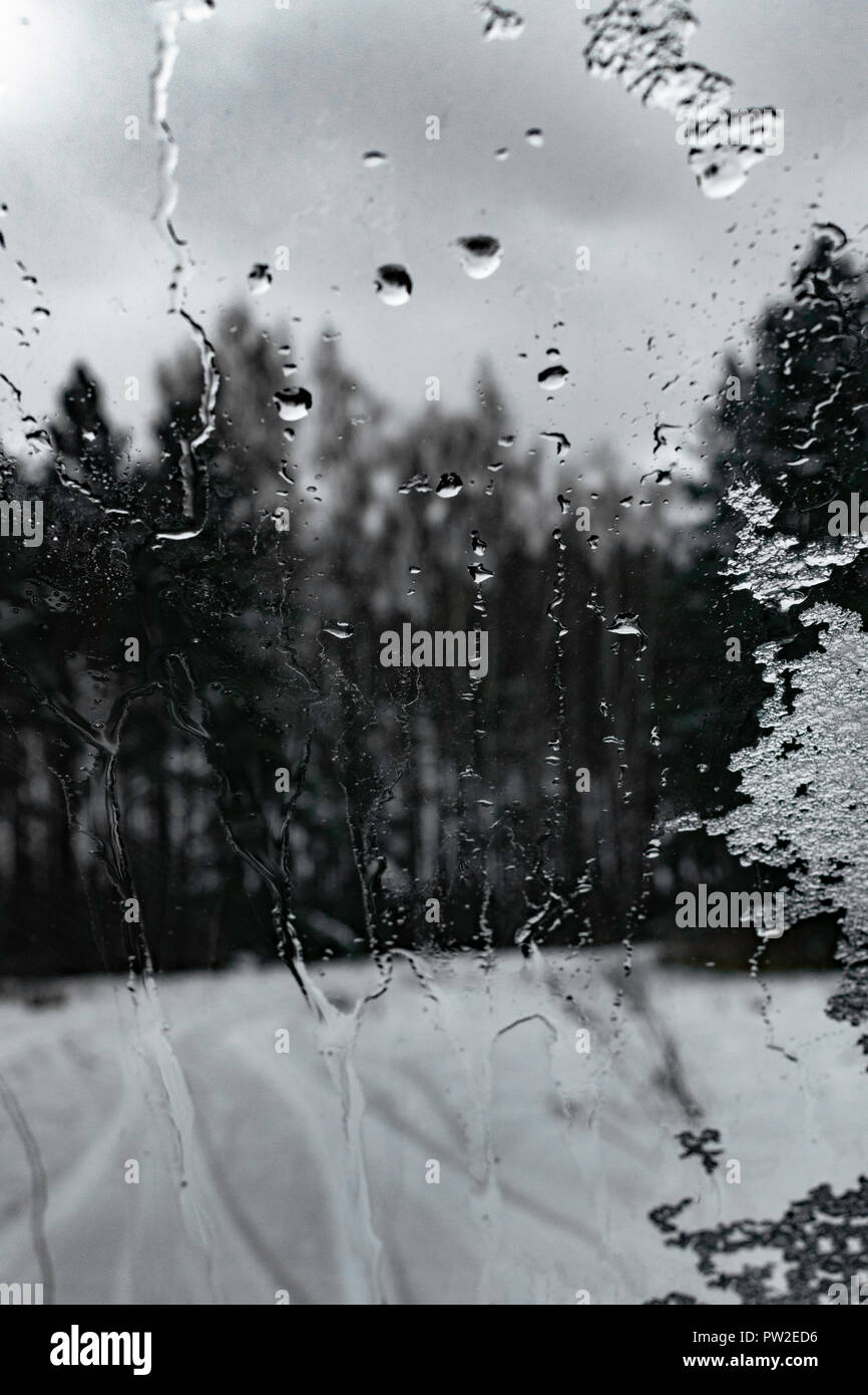 Rain Drops On Glass Window With Background Of Forest In Winter Stock Photo Alamy