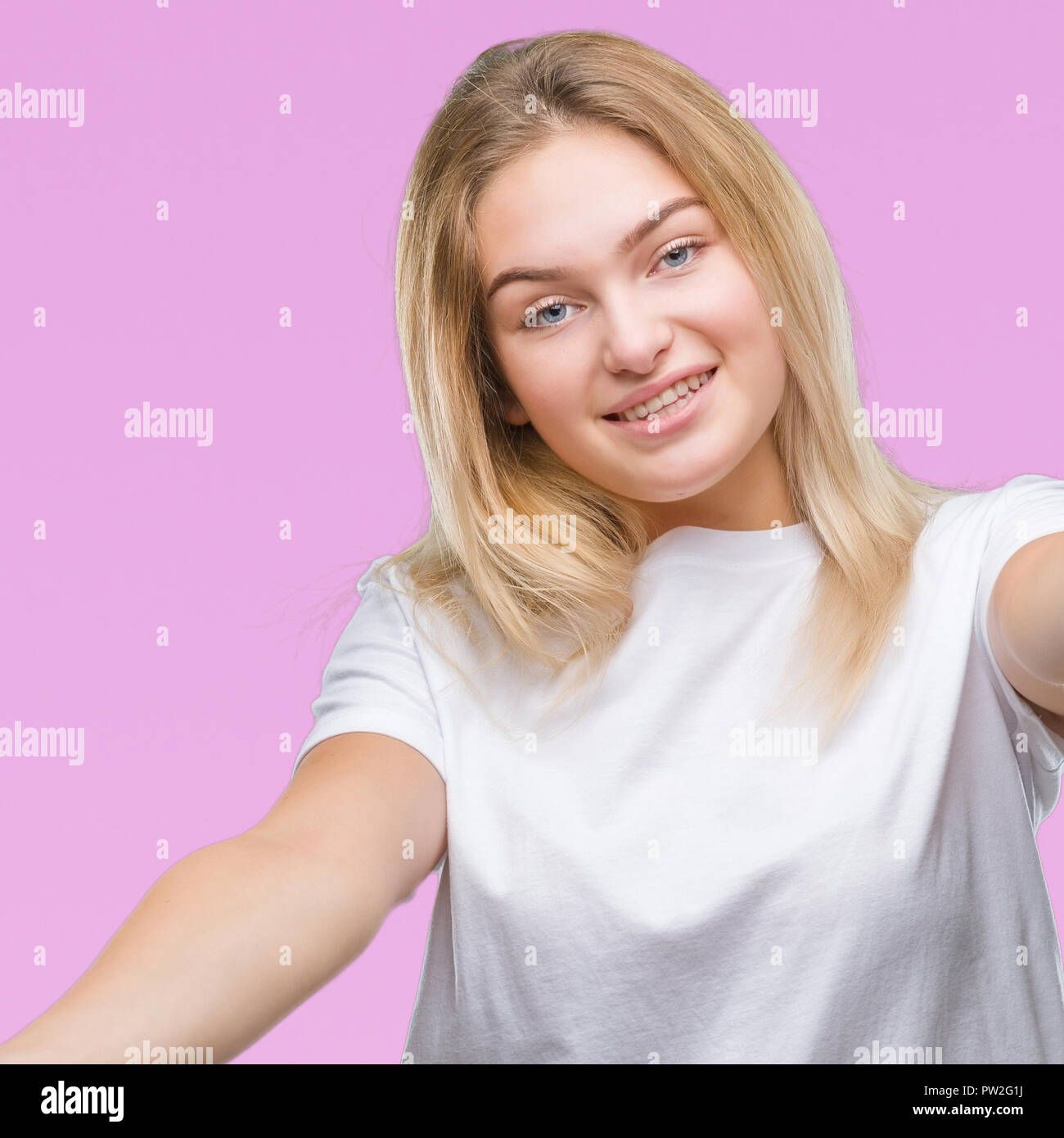 Young caucasian woman over isolated background looking at the camera ...