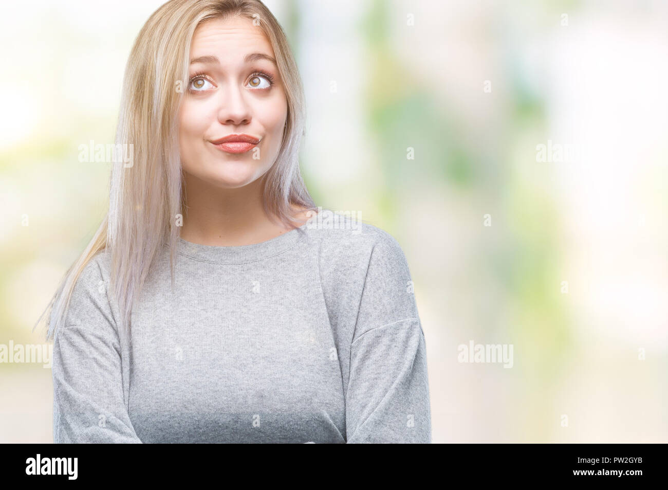Young blonde woman over isolated background smiling looking side and ...