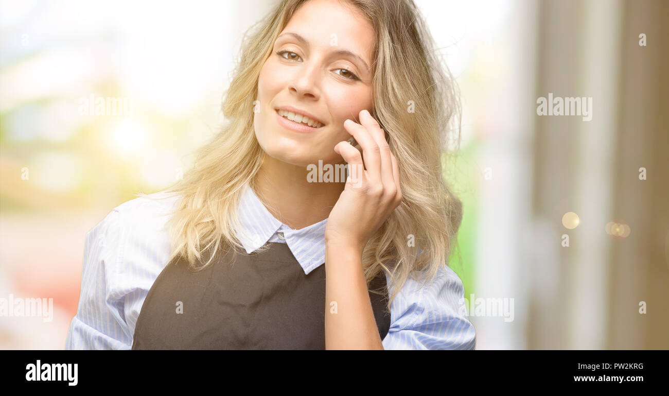 Woman employee wearing apron using hi-res stock photography and images ...