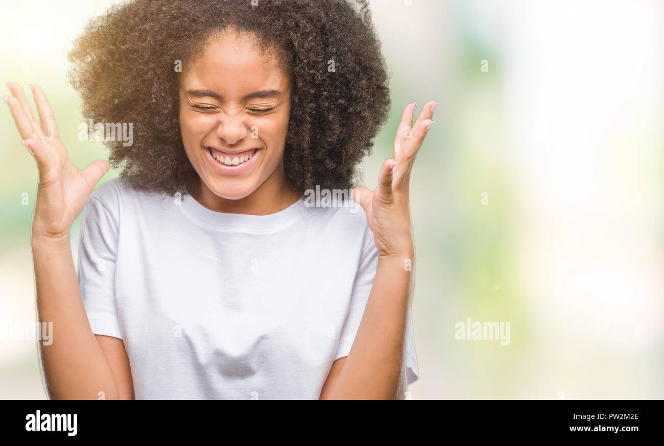 Young afro american woman over isolated background celebrating mad and ...