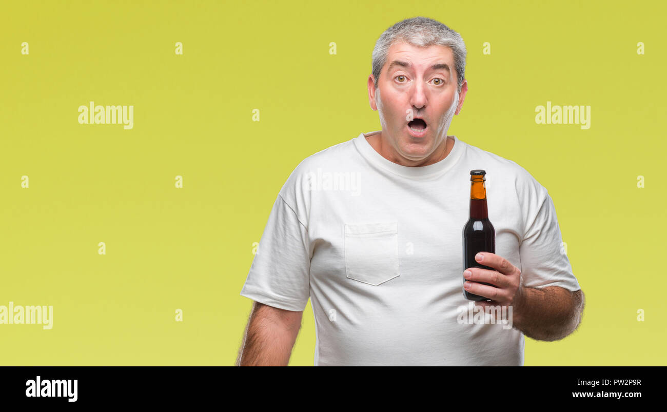 een kopje Verslaving Los Handsome senior man drinking beer bottle over isolated background scared in  shock with a surprise face, afraid and excited with fear expression Stock  Photo - Alamy