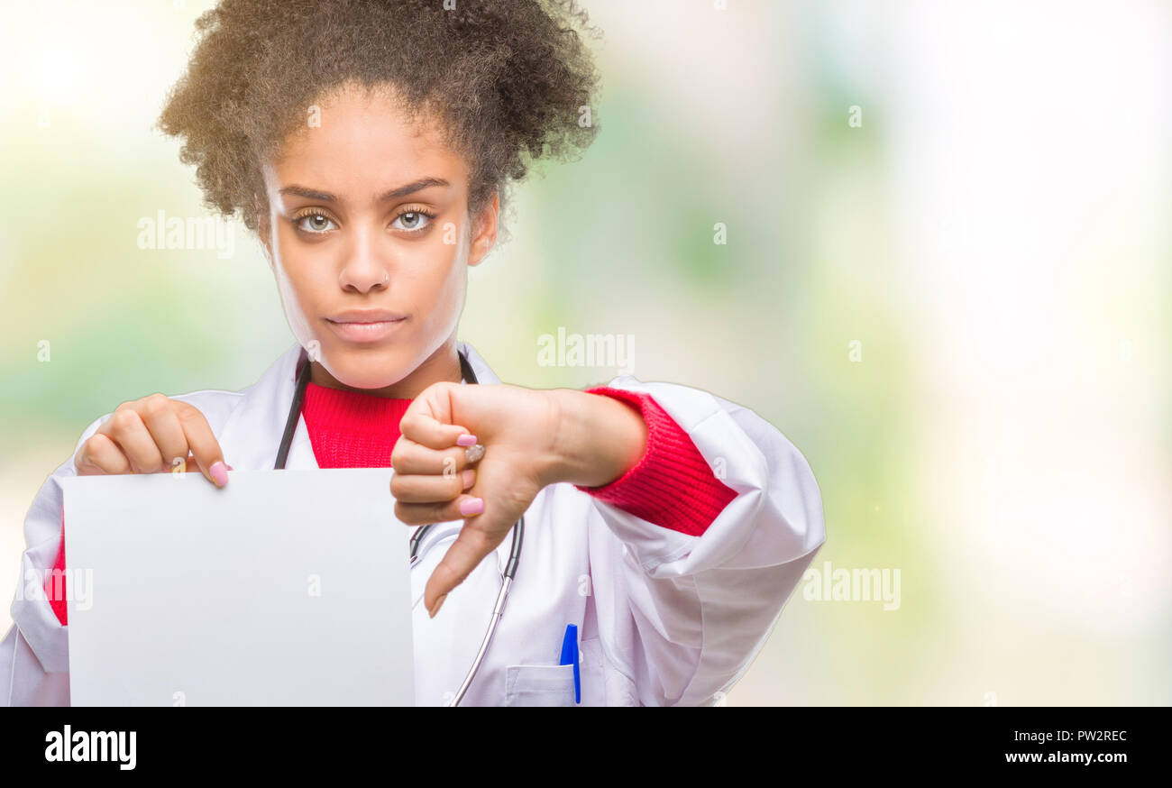 Young afro american doctor woman holding blank paper over isolated ...