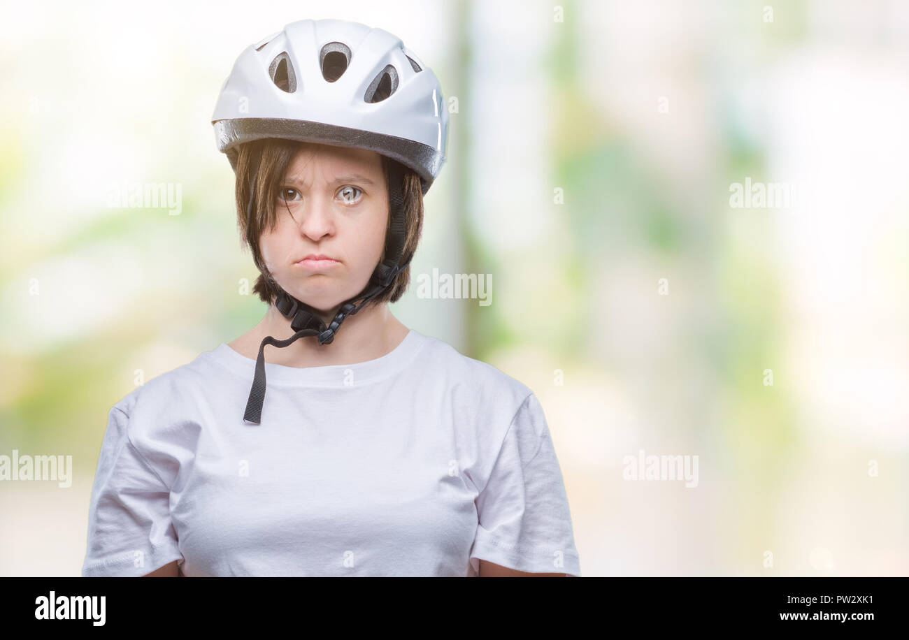 Young adult cyclist woman with down syndrome wearing safety helmet over isolated background with serious expression on face. Simple and natural lookin Stock Photo - Alamy Young adult cyclist woman with down syndrome wearing safety helmet over isolated background with serious expression on face. Simple and natural lookin Stock Photo - Alamy