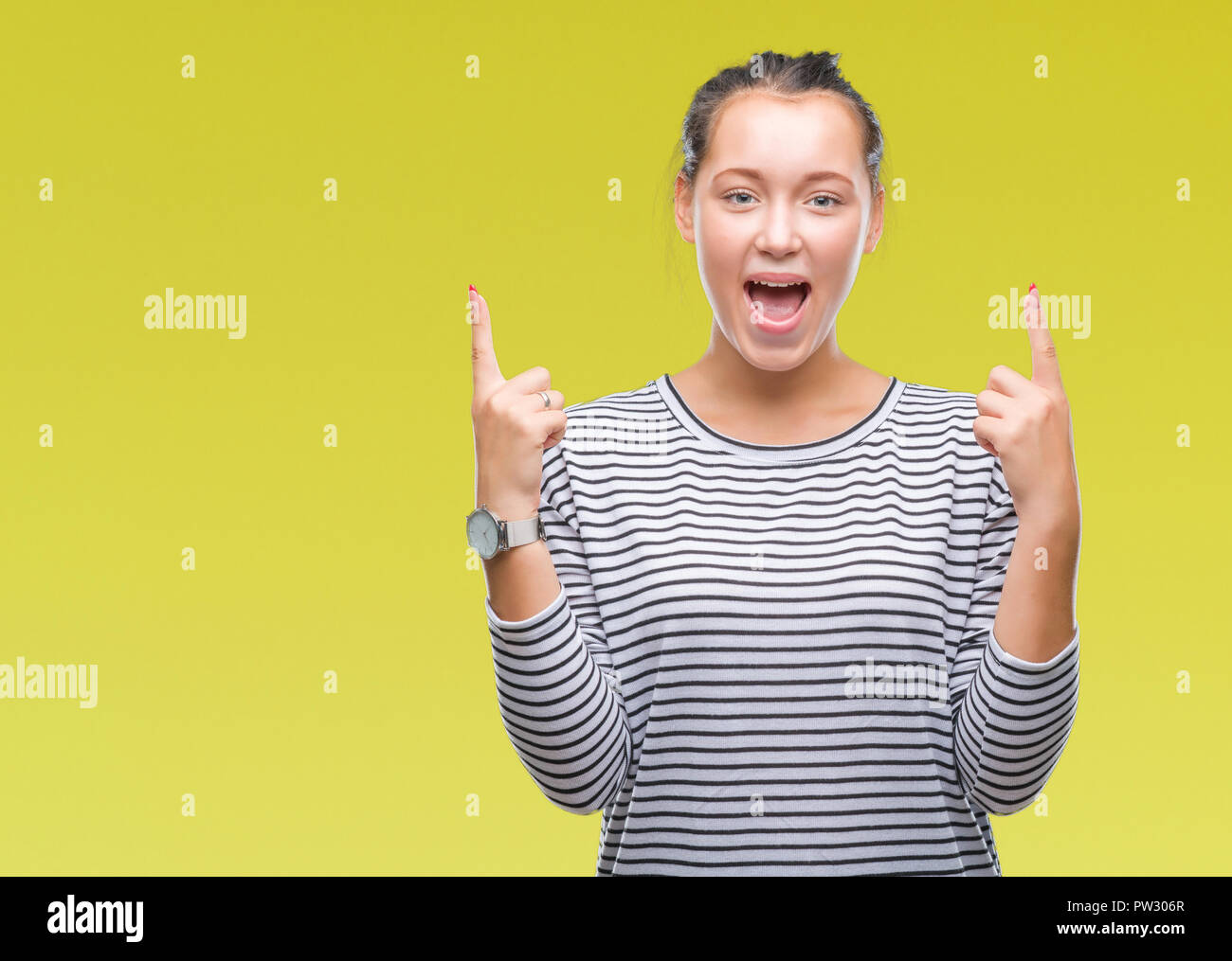 Young beautiful caucasian woman over isolated background amazed and ...