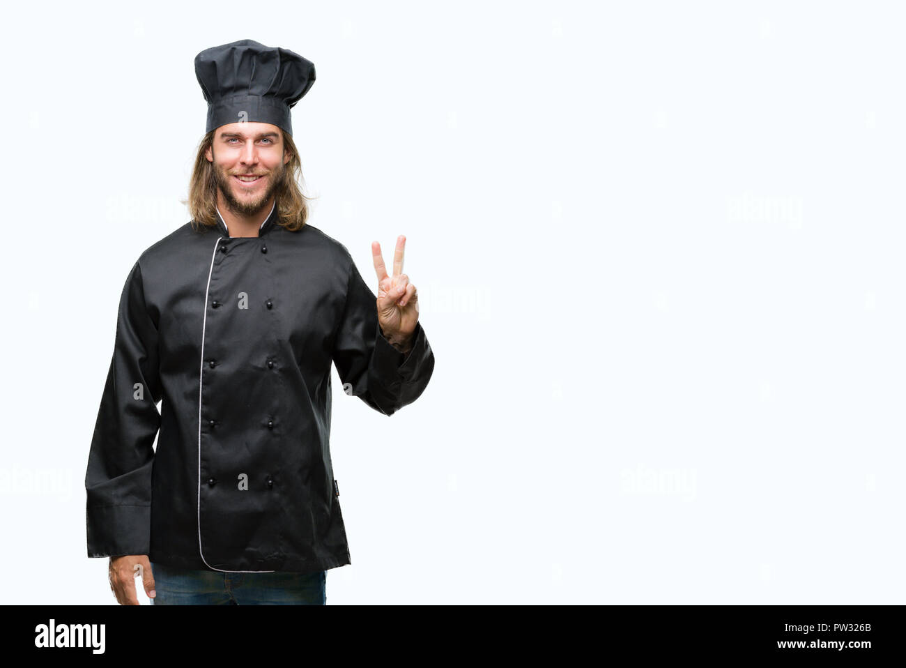 Young handsome cook man with long hair over isolated background showing ...