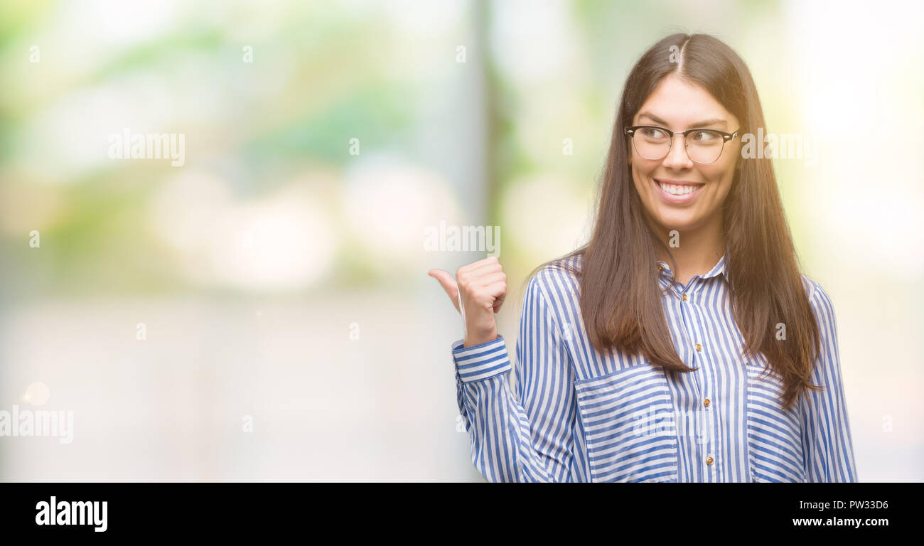 Young beautiful hispanic business woman smiling with happy face looking ...