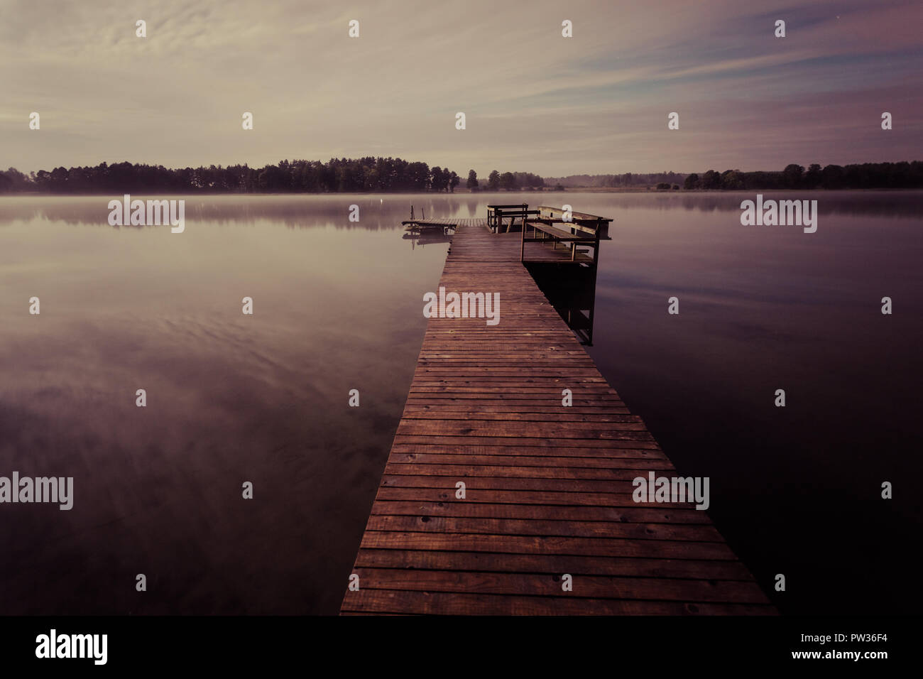 Wooden jetty on the lake at night, long exposure shot Stock Photo