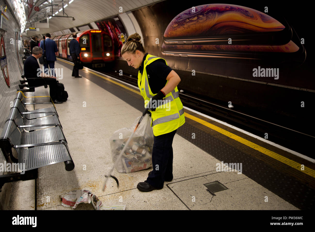 London Tube. Woman cleaning station platform Stock Photo
