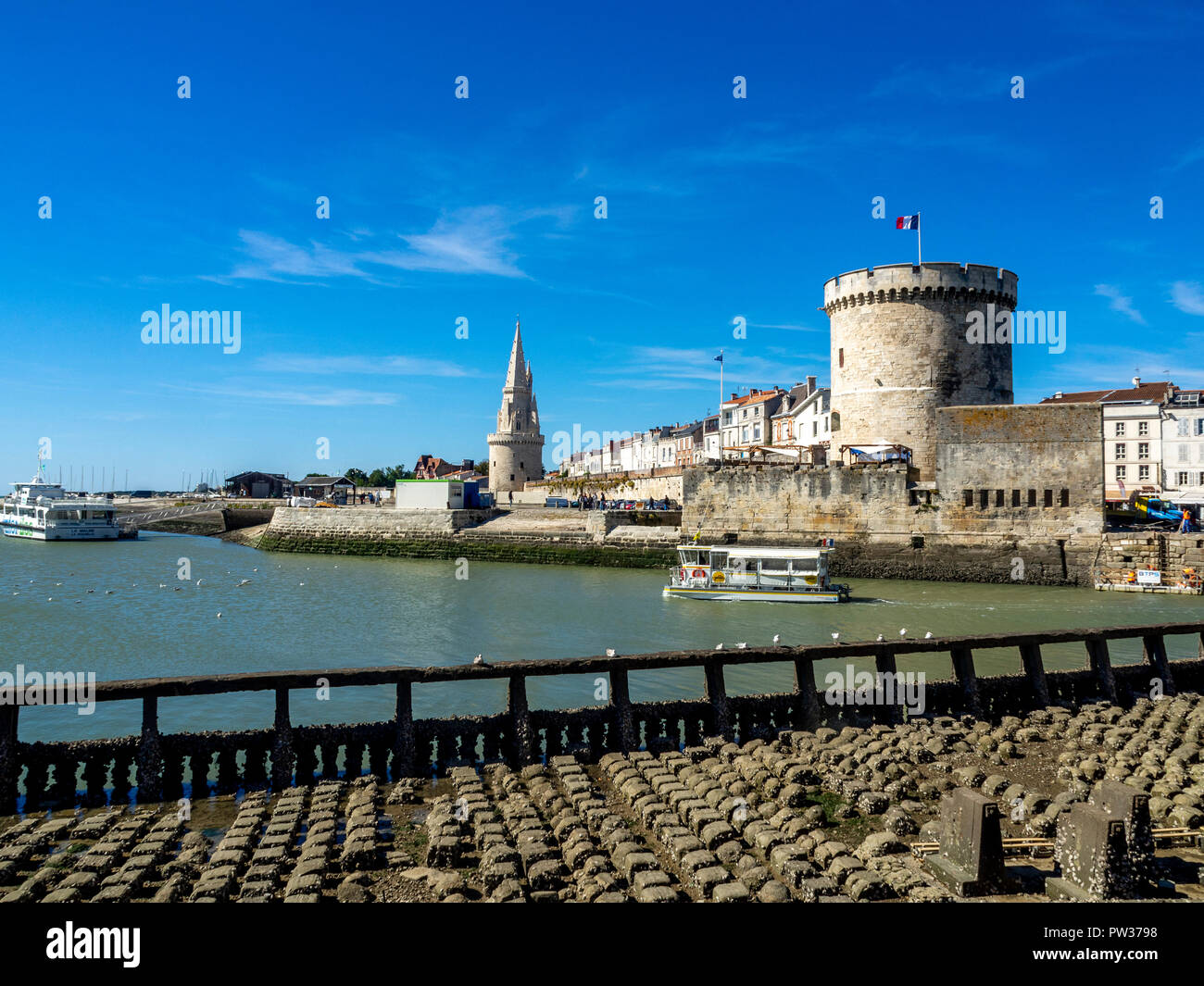 The Lantern Tower (Tour de la Lanterne) and The Chain Tower (Tour de la Chaine) at the entrance to the ancient port of La Rochelle, Charente Maritime, Stock Photo