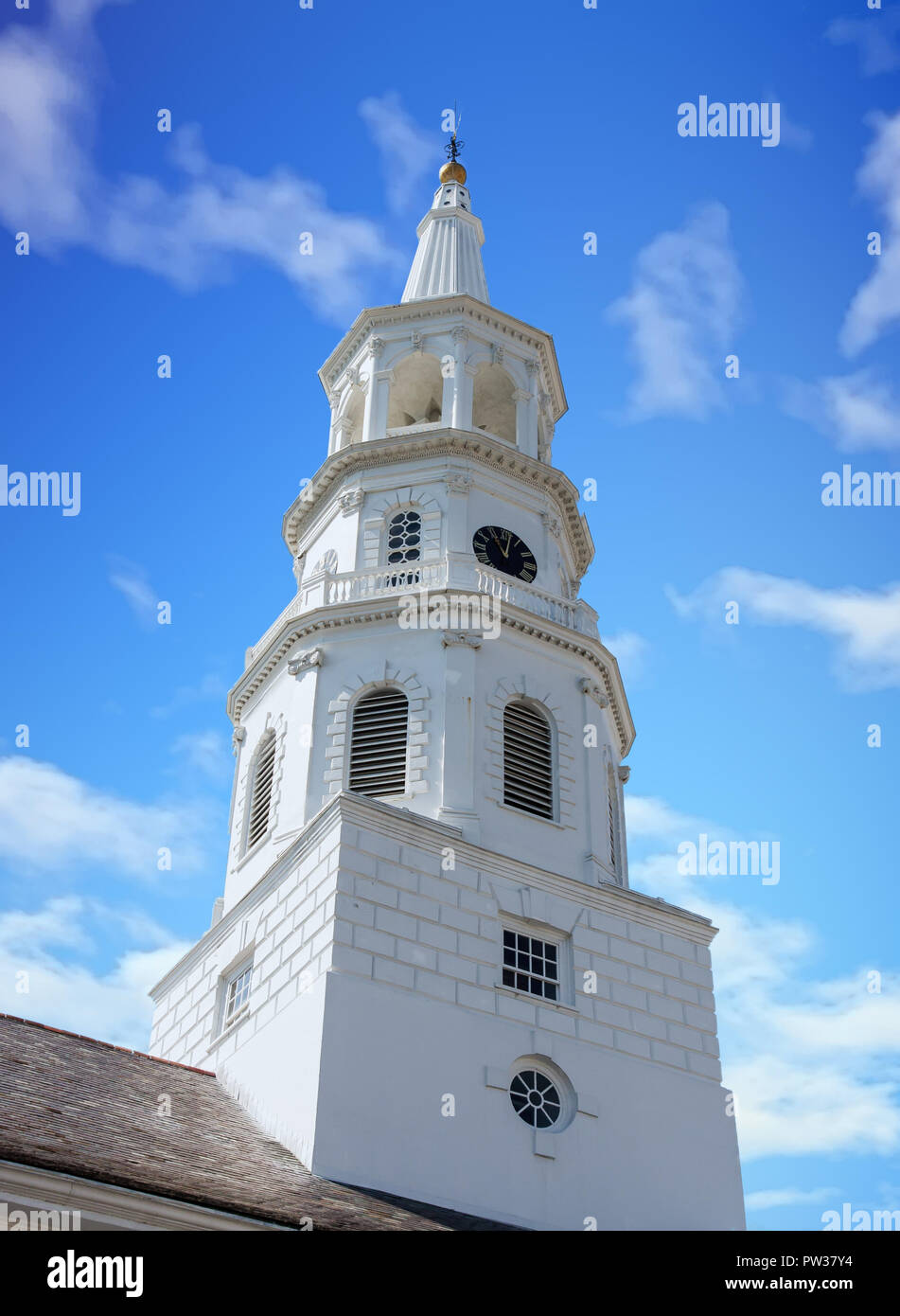 A white church steeple rising into a clear blue sky with clock Stock ...