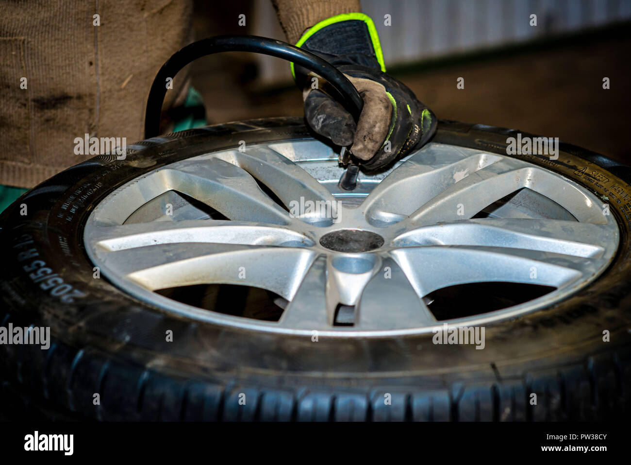 Seasonal tyre replacement. Seasonal tyre replacement. Auto mechanic changing car wheel. Stock Photo