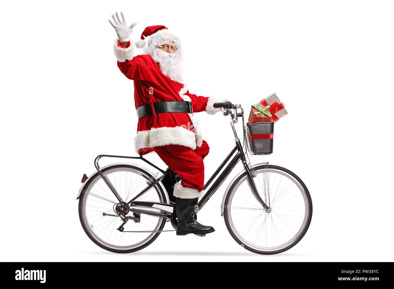 Full length shot of Santa Claus riding a bicycle and waving isolated on white background Stock Photo