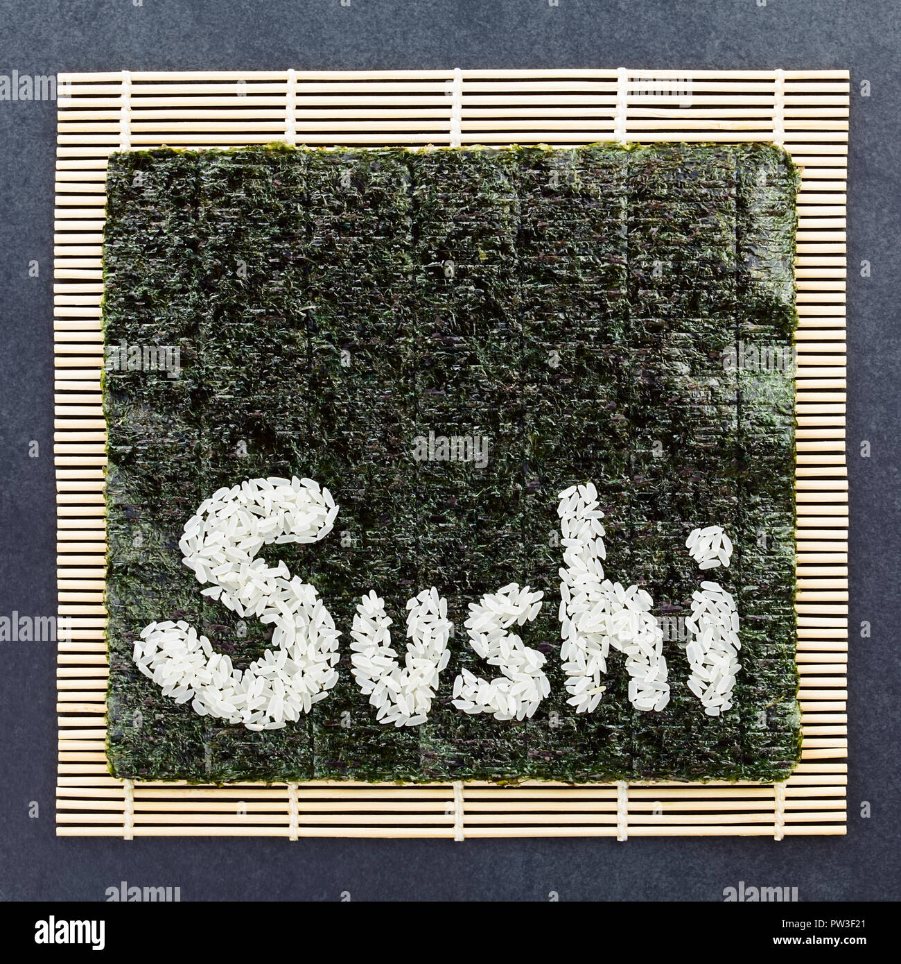 Sushi ingredients, nori seaweed on makisu bamboo mat for rolling, fresh raw  salmon, raw sushi rice, soy sauce and chopsticks on the side Stock Photo -  Alamy