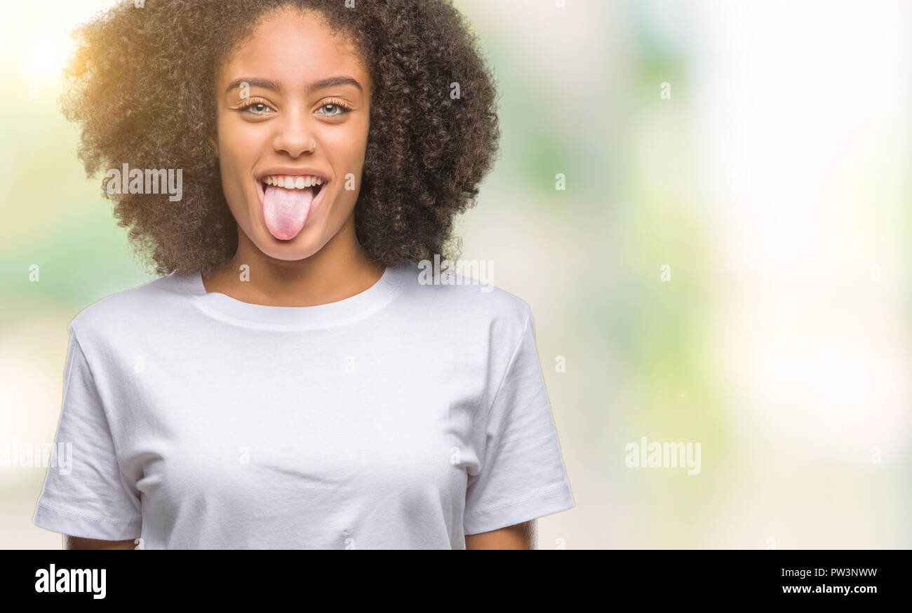 Young afro american woman over isolated background sticking tongue out ...