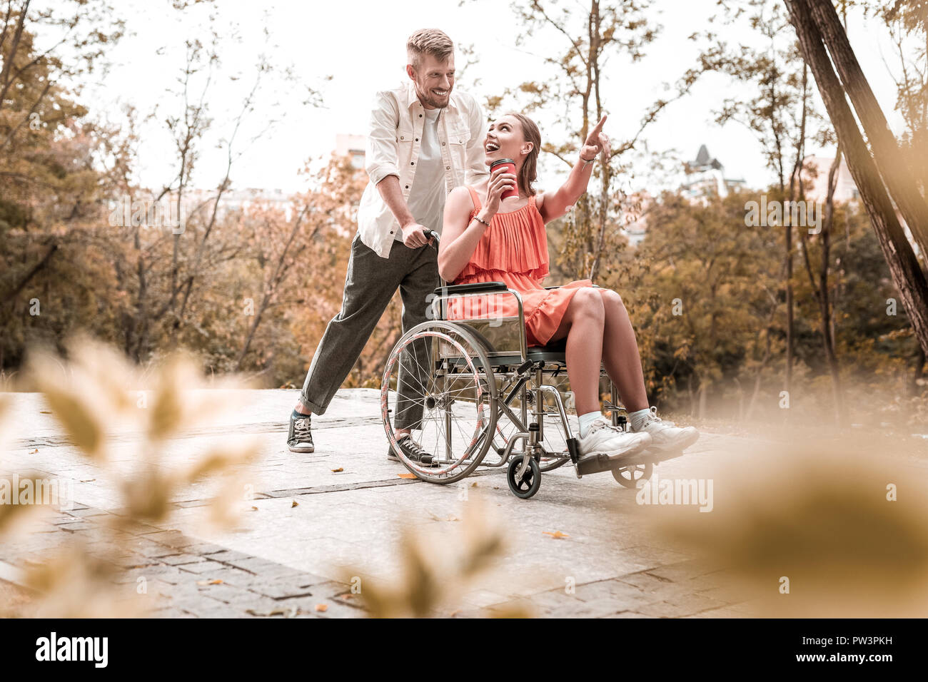 Excited invalid pointing to the distance and looking happy Stock Photo