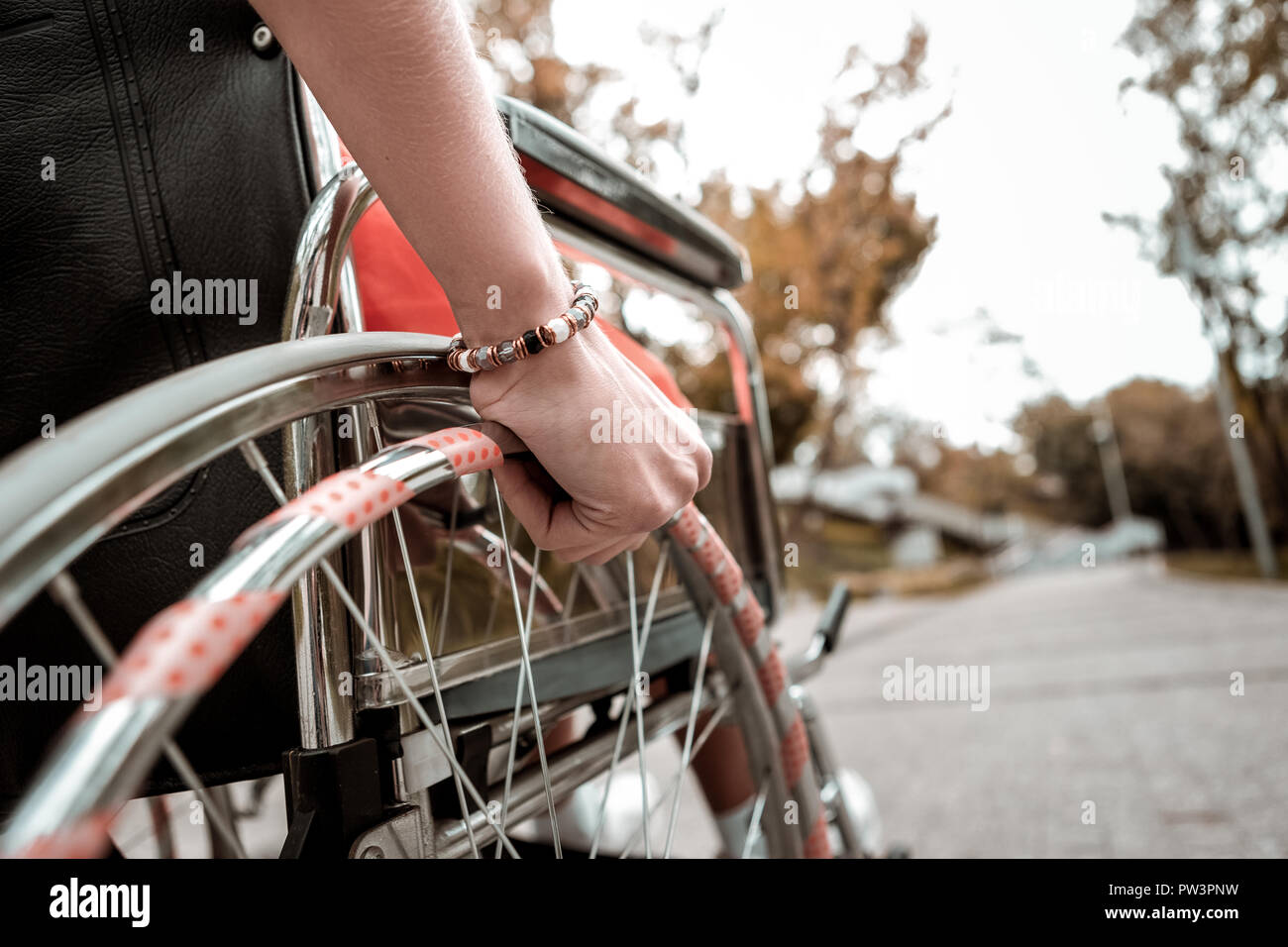 Close view of the hand placed on the wheelchair Stock Photo Alamy