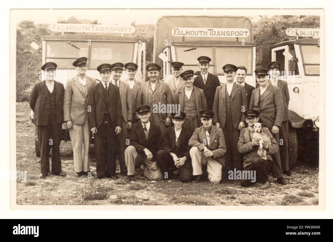 Early 1900s postcard of a group of Falmouth bus drivers wearing caps, posing next to buses, bus company is Falmouth Transport, 1930s, Falmouth, Cornwall, U.K. Stock Photo