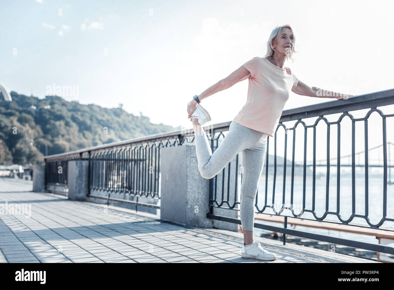 Mature blonde woman stretching hi-res stock photography and images - Alamy