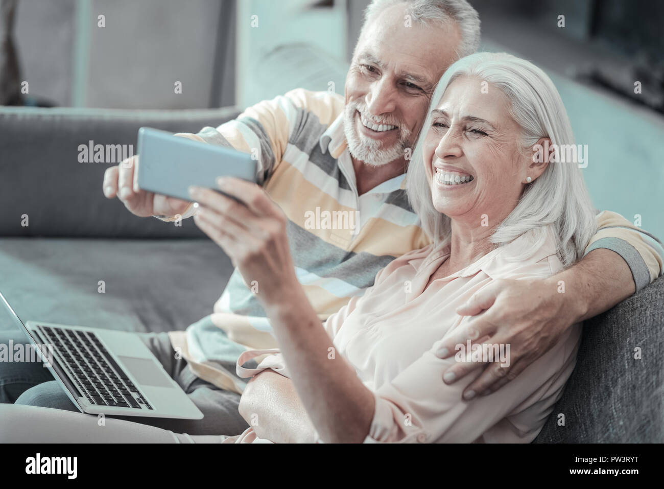 Joyful positive couple taking selfie Stock Photo