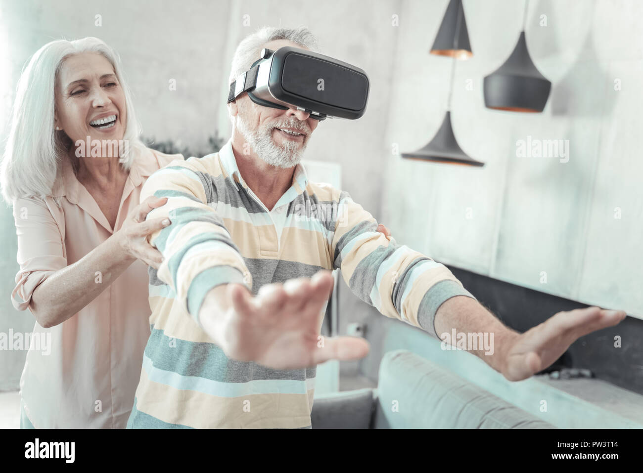 Nice elderly man experiencing virtual reality Stock Photo