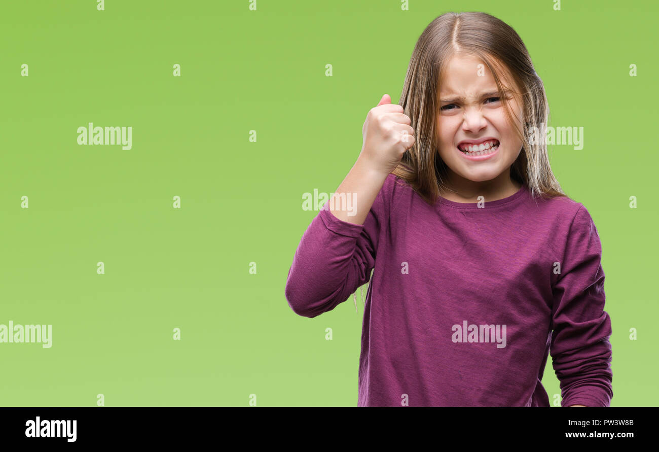 Young beautiful girl over isolated background angry and mad raising ...
