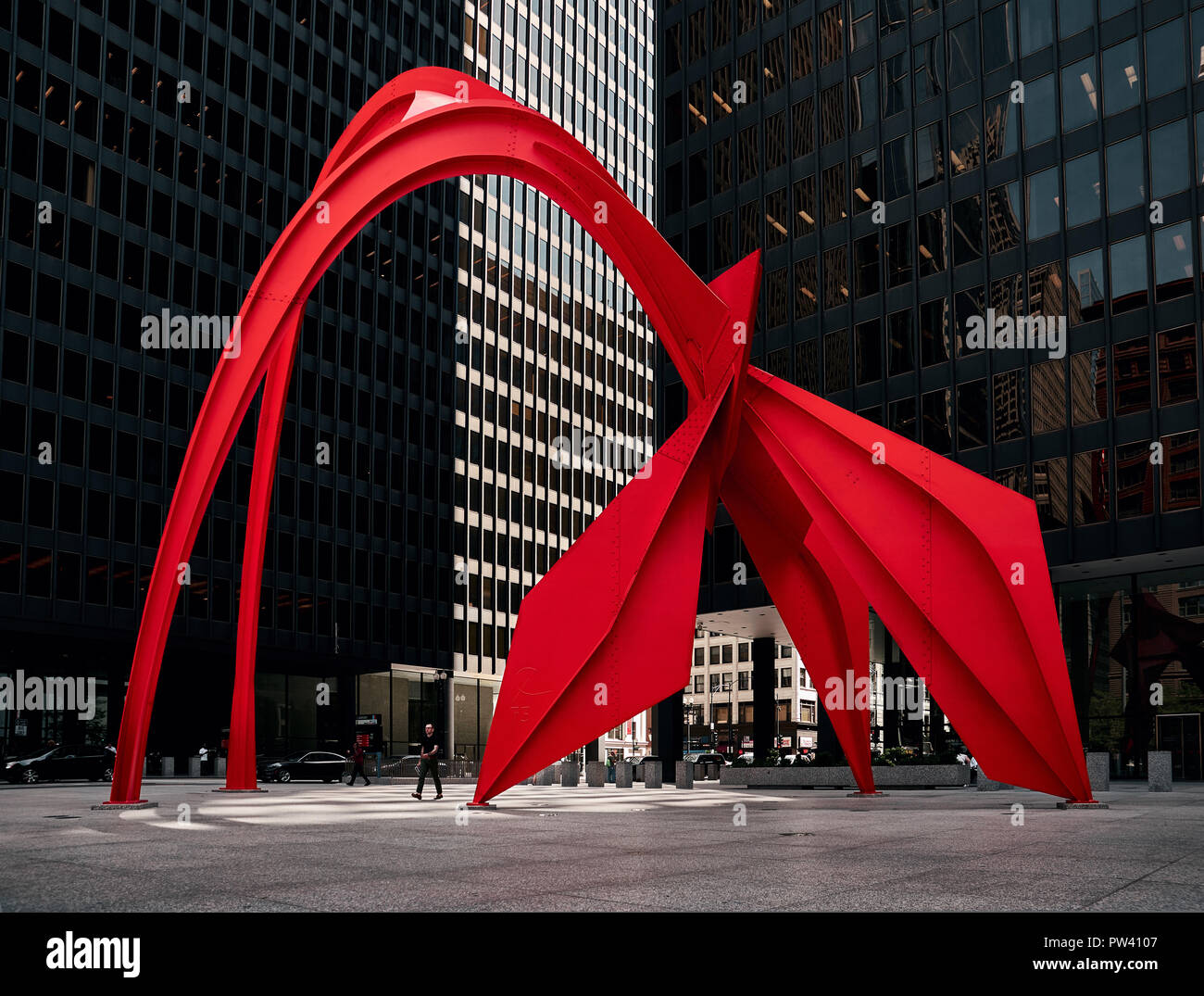 Calder's Flamingo sculpture in the middle of the vibrant public place, Federal Plaza, in Chicago, enclosed by high-rise office buildings Stock Photo