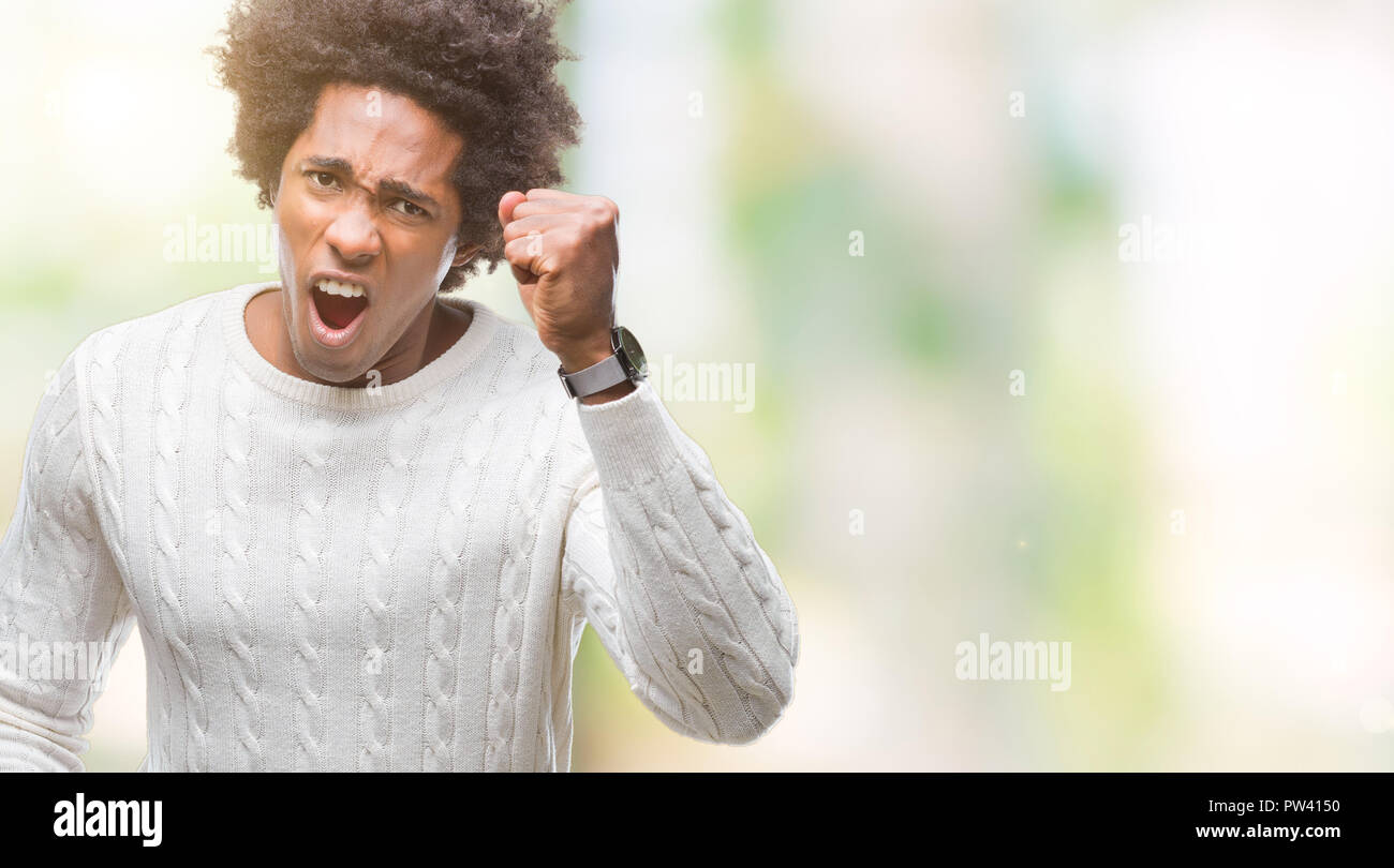 Afro american man over isolated background angry and mad raising fist ...