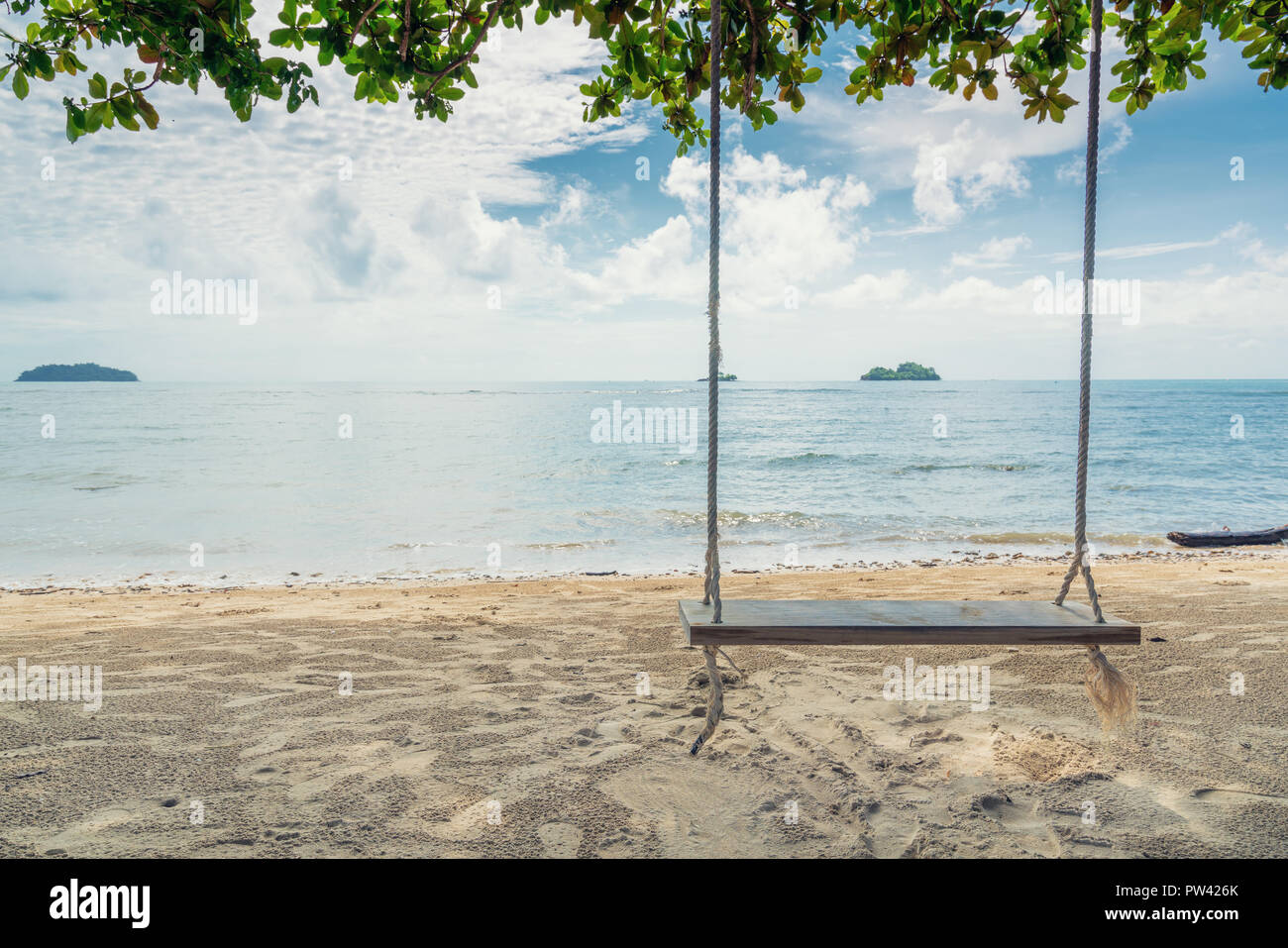 Wooden swing chair hanging on tree near beach at island in Phuket,  Thailand. Summer Vacation Travel and Holiday concept Stock Photo - Alamy