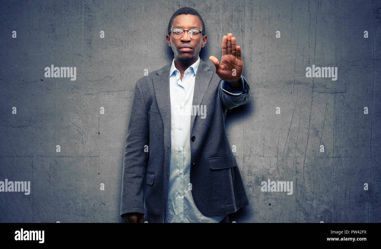 African black man wearing jacket annoyed with bad attitude making stop sign  with hand, saying no, expressing security, defense or restriction, maybe p  Stock Photo - Alamy