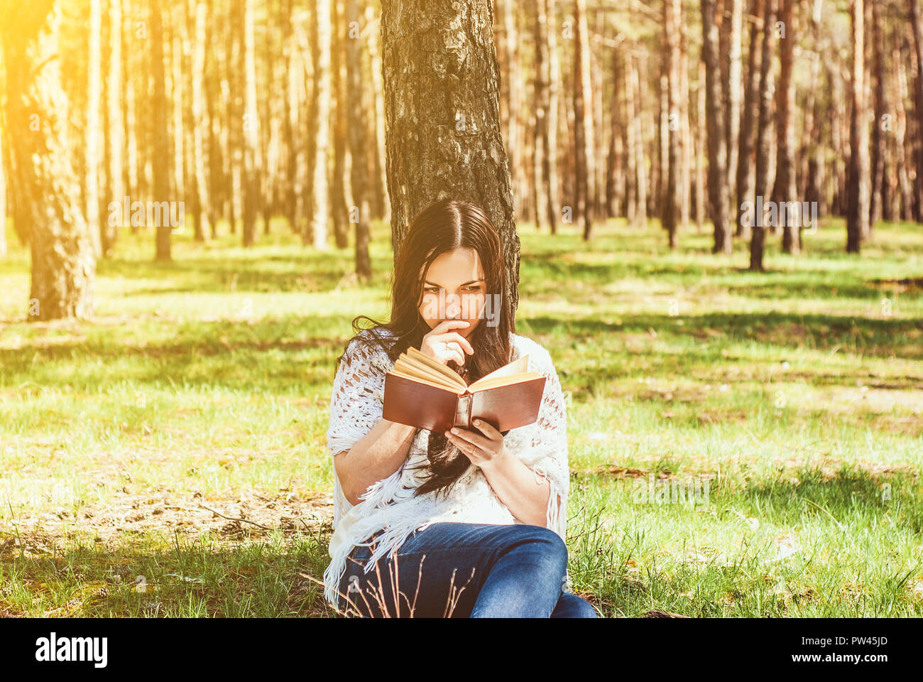 Woman relaxing reading book at park Stock Photo - Alamy